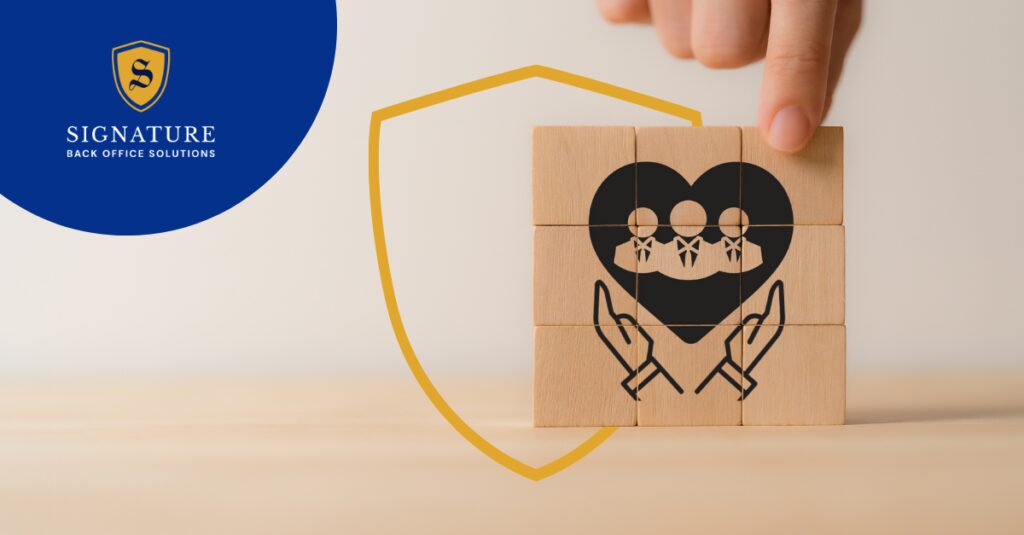 A hand assembles wooden blocks displaying a heart with three stylized employees and supporting hands, symbolizing EOR services.