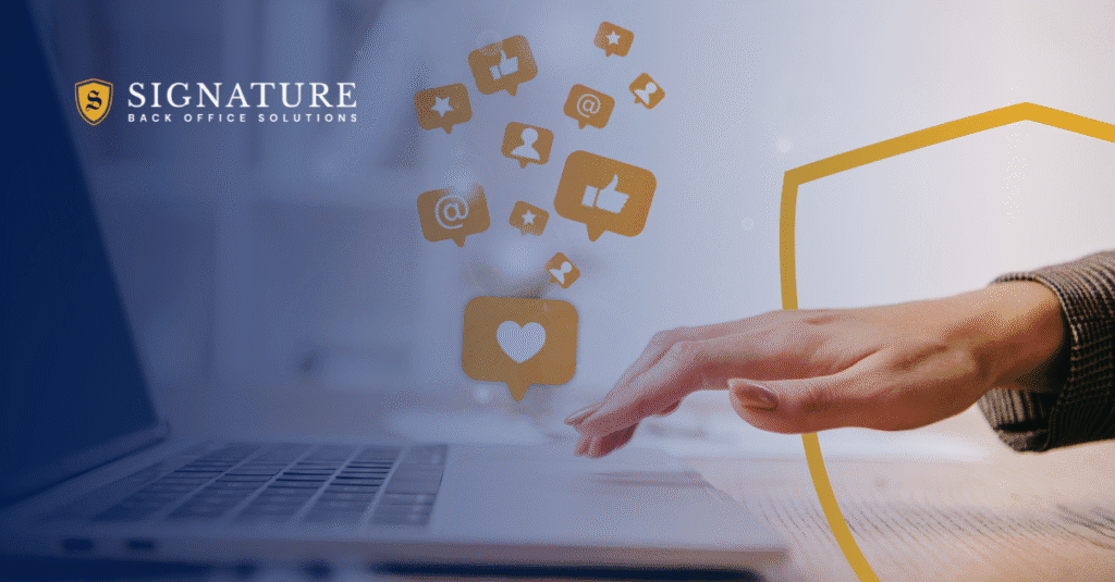 Hand reaching toward laptop with social media icons floating above, representing social media content for staffing firms and digital marketing strategies.