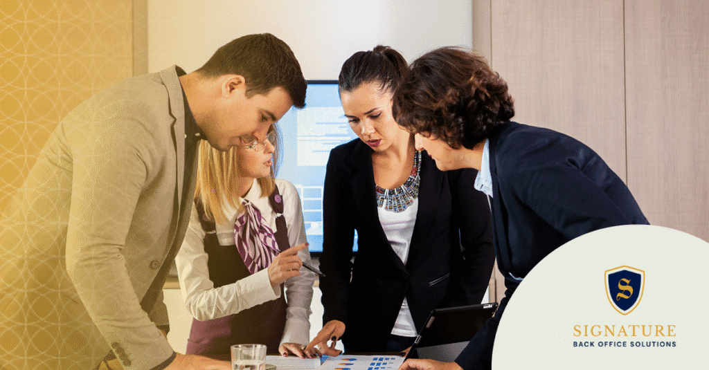 Business professionals reviewing client data and growth strategies for niche staffing firm success.