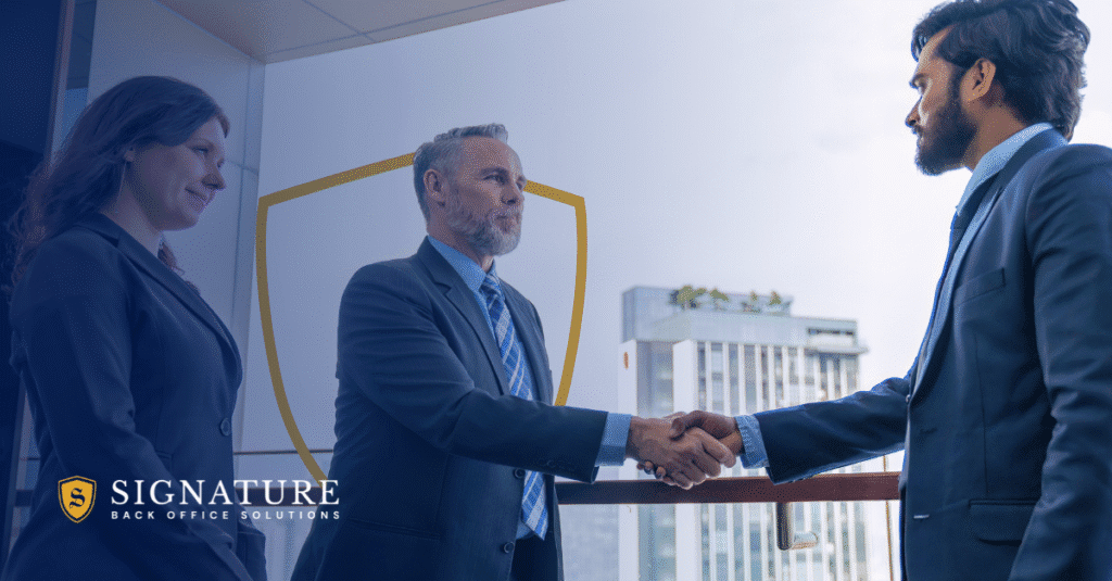 Business executives shaking hands in office representing contract staffing partnerships and firm valuation.