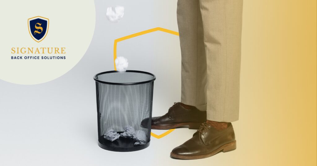 Professional discarding outdated documents symbolizing transition from factoring to EOR services.