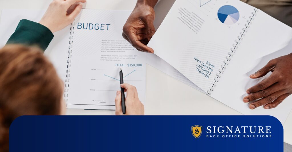 Business professionals reviewing staffing KPIs 2026 and budget documents during Q1 financial analysis.