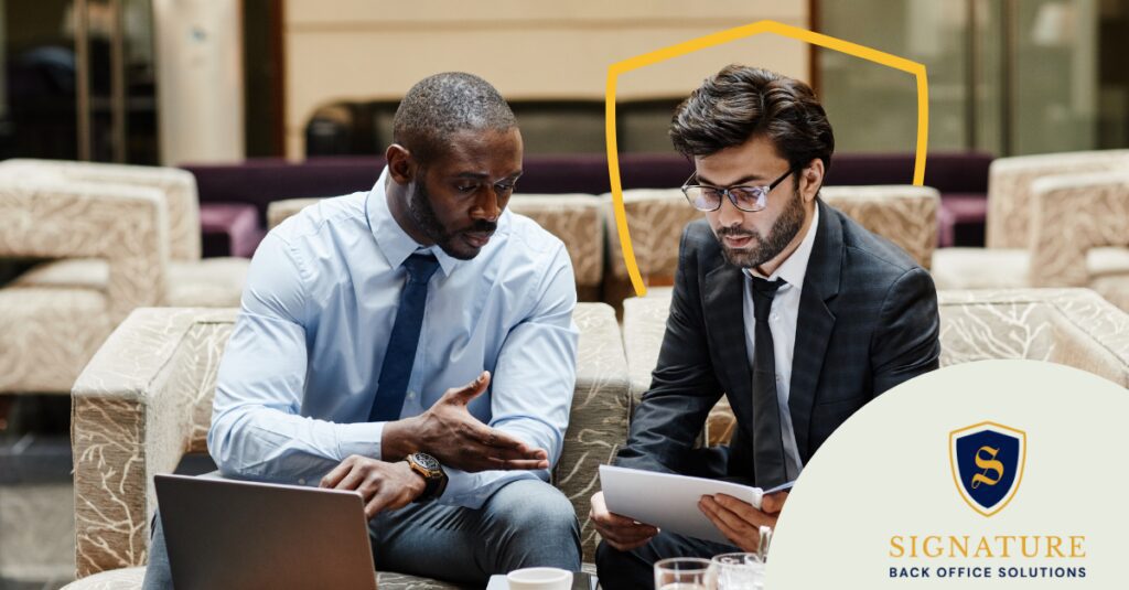 Two staffing professionals discussing when to convert temp to direct hire over a laptop.