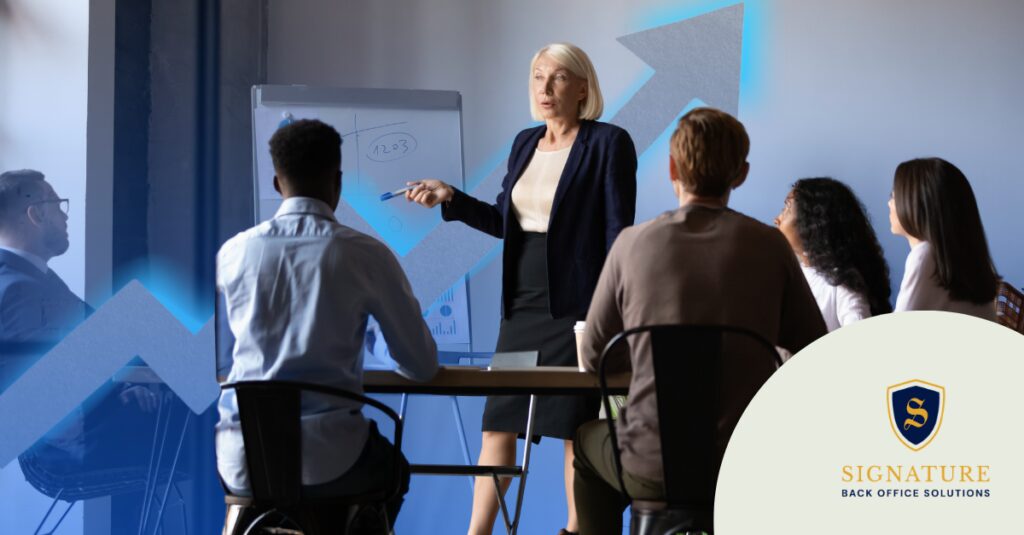 Contract staffing team meeting with business leader presenting growth strategy