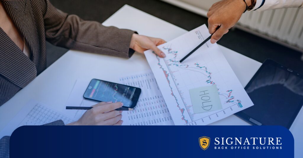 Team reviewing financial charts to assess staffing firm valuation